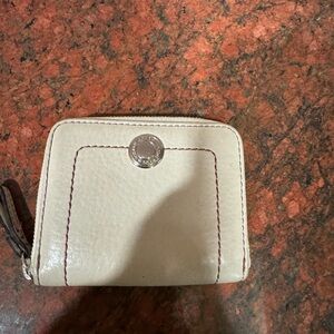 Cream Coach mini wallet with zipper.
